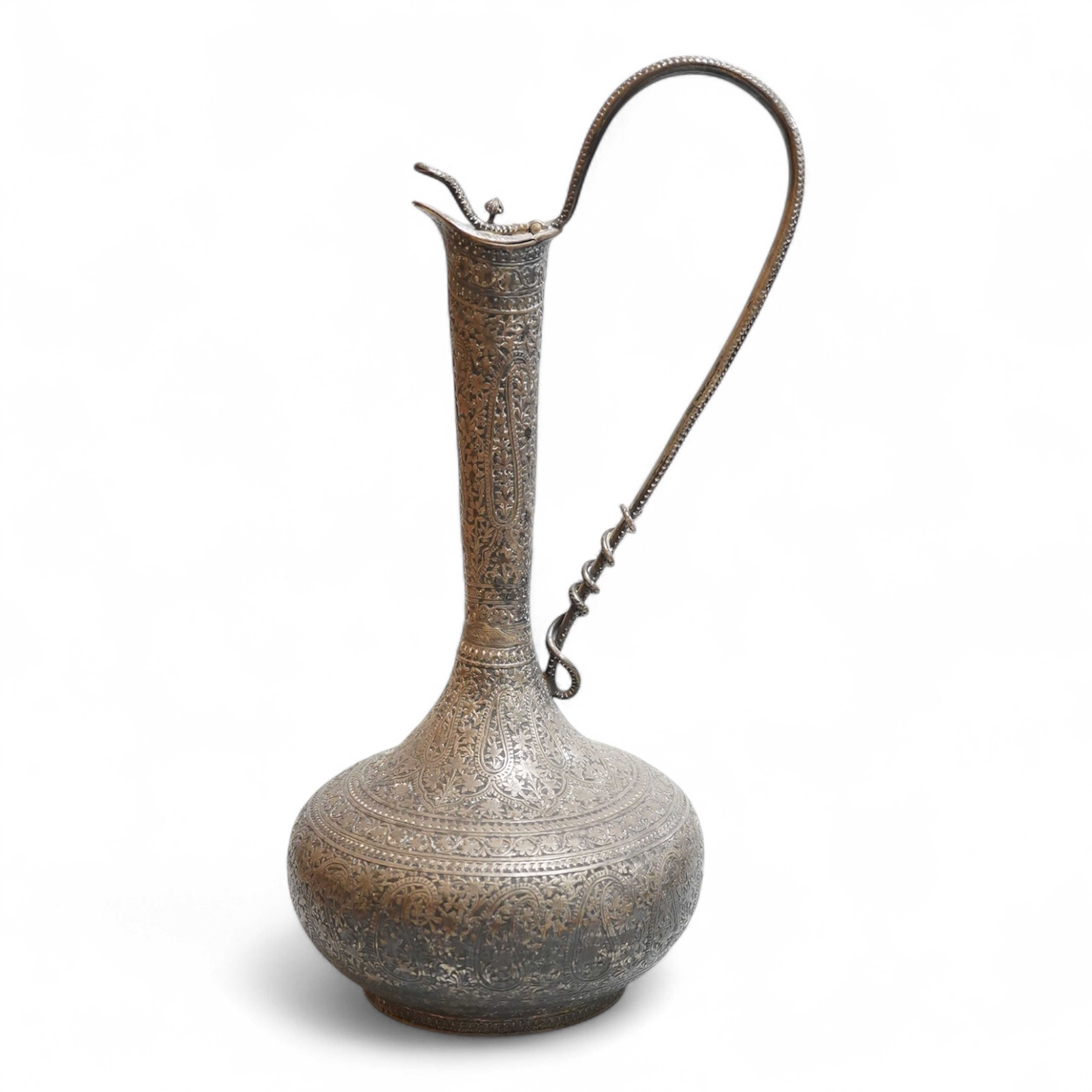 A late 19th century Indian white metal ewer, with extensive foliate decoration and cobra handle, height 30.3cm.